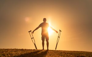 Man letting go of crutches able to walk again